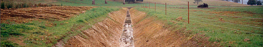 Land drainage image of drain trench in a field